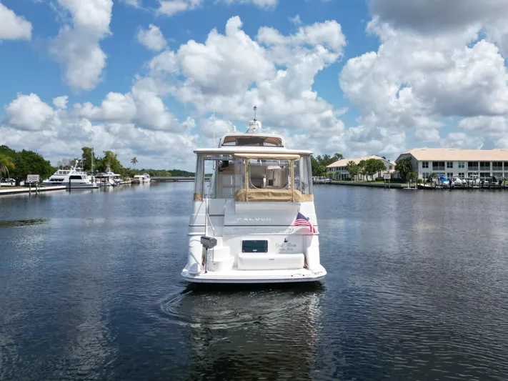  Yacht Photos Pics 2005 Carver 390 MY yacht cruising on a calm waterway under a partly cloudy sky.
