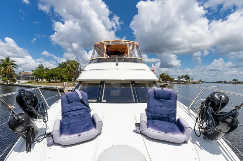  Yacht Photos Pics 2005 Carver 390 MY yacht with blue deck chairs, cruising on a sunny day.