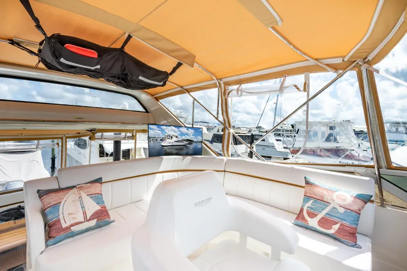  Yacht Photos Pics Luxurious interior of 2005 Carver 390 MY yacht with white seating and nautical decor.