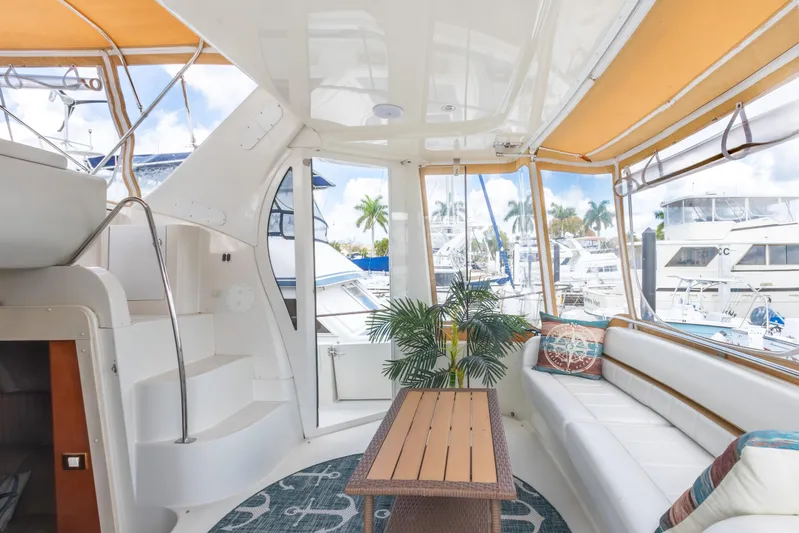  Yacht Photos Pics 2005 Carver 390 MY yacht interior with seating, table, and marina view.