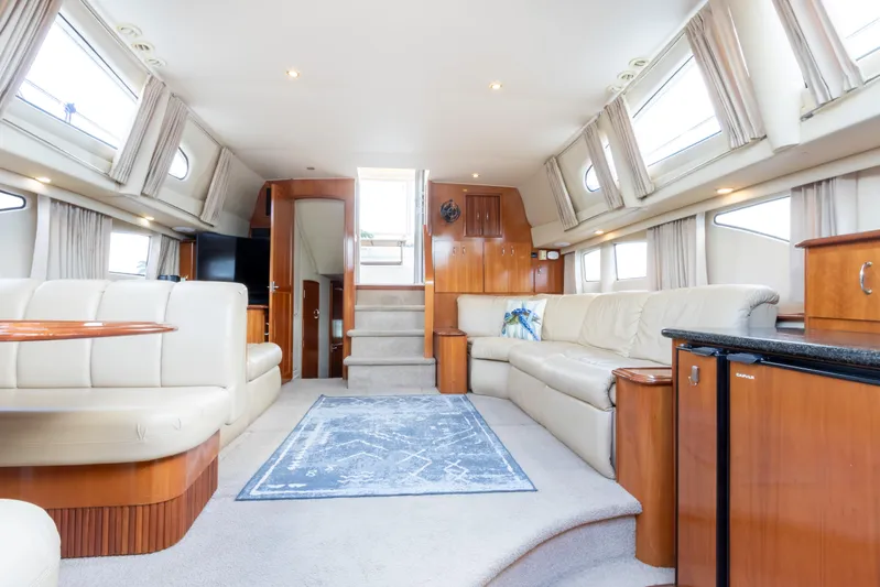  Yacht Photos Pics Luxurious interior of 2005 Carver 390 MY yacht with plush seating and elegant wood finishes.