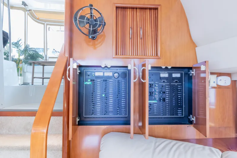  Yacht Photos Pics Electrical panel inside 2005 Carver 390 MY yacht, featuring wooden cabinetry and modern controls.
