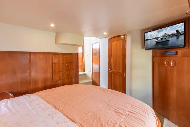  Yacht Photos Pics 2005 Carver 390 MY yacht bedroom with wood paneling and mounted TV.