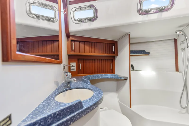 Resolute Yacht Photos Pics Luxurious Blue Jacket 40 yacht bathroom with modern fixtures and wooden cabinetry, 2015 model.