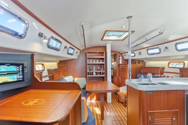Resolute Yacht Photos Pics Luxurious interior of 2015 Blue Jacket 40 sailboat with wood finish and modern amenities.