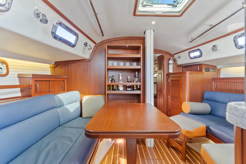Resolute Yacht Photos Pics Luxurious Blue Jacket 40 yacht interior with wooden finishes, blue seating, and ample natural light.
