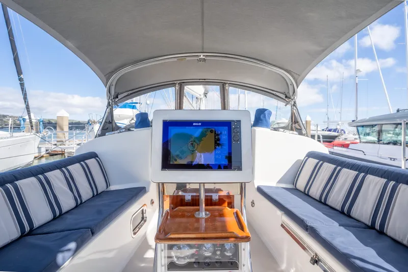 Resolute Yacht Photos Pics Interior of 2015 Blue Jacket 40 sailboat with striped seating and navigation screen.