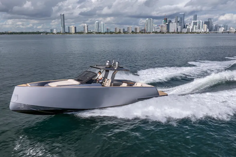 Live A Little Yacht Photos Pics 2021 Pardo Yachts 43 cruising on water with city skyline in background.