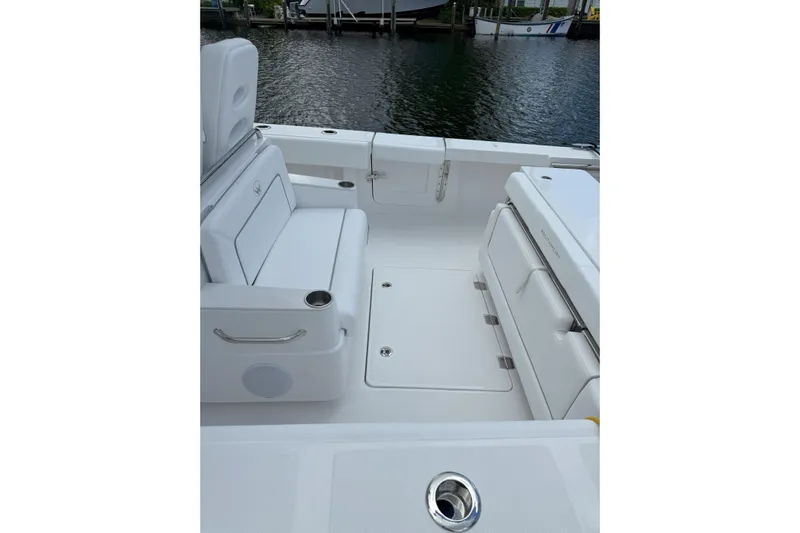  Yacht Photos Pics 2026 Southport 30 FE boat interior with white seating and storage compartments.