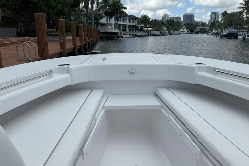  Yacht Photos Pics 2026 Southport 30 FE boat interior with white seating, dockside view, and waterfront backdrop.