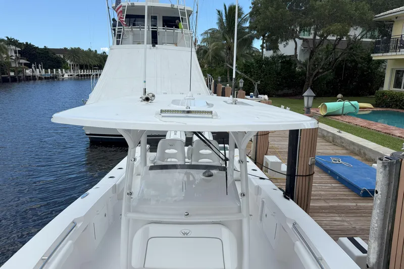  Yacht Photos Pics 2026 Southport 30 FE boat docked by a canal with lush surroundings.