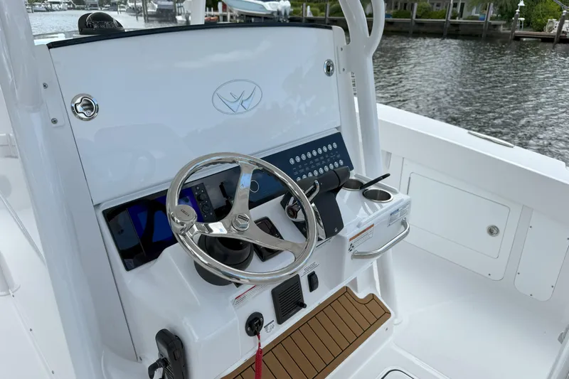  Yacht Photos Pics 2026 Southport 30 FE boat helm with steering wheel and control panel.