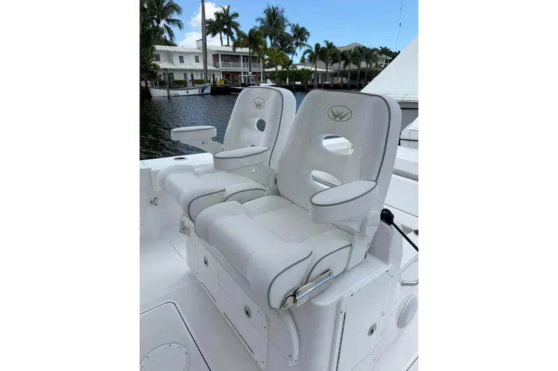  Yacht Photos Pics Luxury seating on 2026 Southport 30 FE boat, featuring plush white upholstery and armrests.