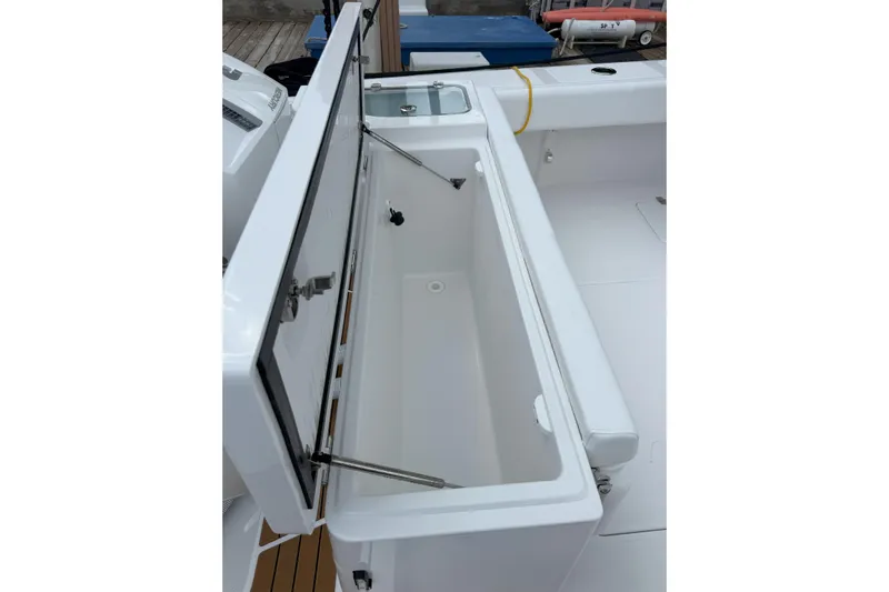  Yacht Photos Pics Open storage compartment on 2026 Southport 30 FE boat, showcasing spacious interior.