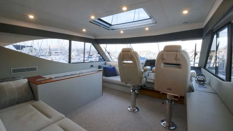  Yacht Photos Pics Luxurious interior of 2020 Maritimo M51 yacht with plush seating and panoramic windows.