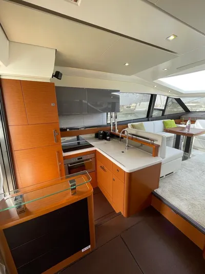  Yacht Photos Pics Luxurious interior of a 2011 Prestige 500 S yacht with modern kitchen and seating area.