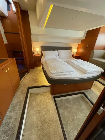  Yacht Photos Pics Luxurious cabin interior of 2011 Prestige 500 S yacht with cozy bed and elegant lighting.