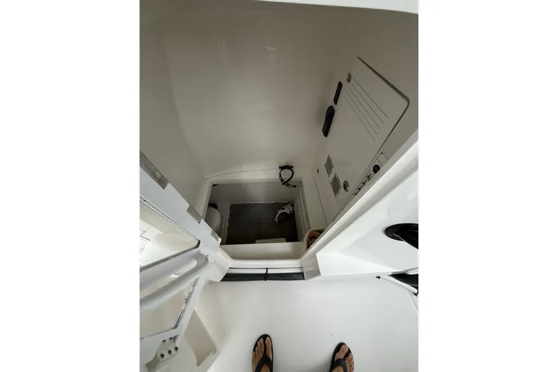  Yacht Photos Pics Interior view of 2020 Contender 39 ST boat cabin, showing compact space and equipment.