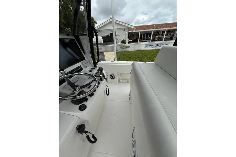  Yacht Photos Pics 2020 Contender 39 ST boat interior with steering wheel and seating area.