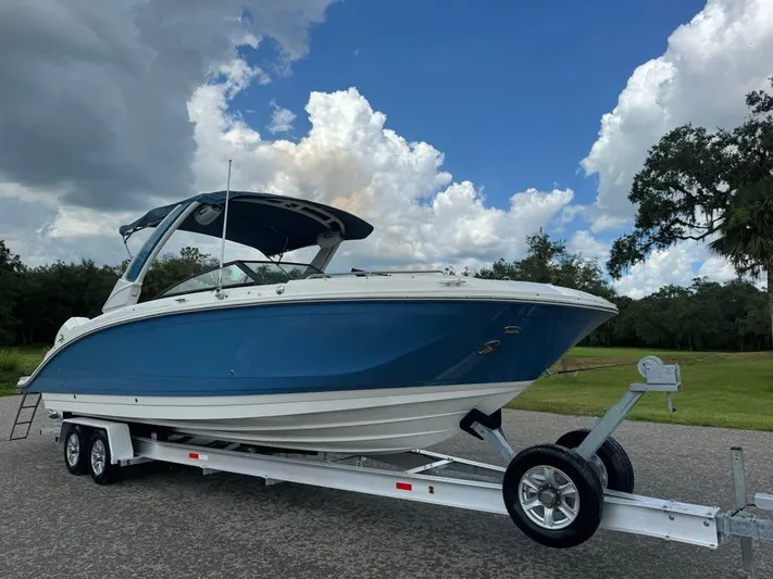 Yacht Photos Pics 2022 Sea Ray SDX 290 Outboard boat on trailer under cloudy sky.