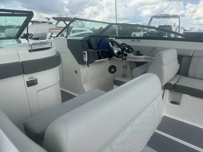  Yacht Photos Pics 2022 Sea Ray SDX 290 Outboard boat interior with modern dashboard and seating.