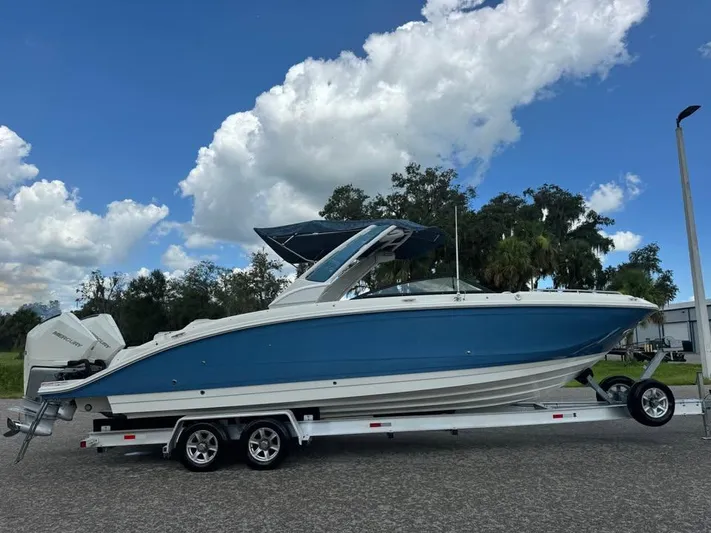  Yacht Photos Pics 2022 Sea Ray SDX 290 Outboard boat on trailer under blue sky.