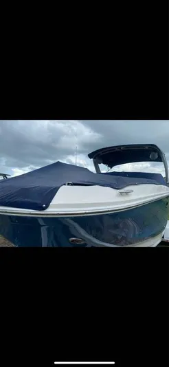  Yacht Photos Pics 2022 Sea Ray SDX 290 Outboard boat with blue cover under cloudy sky.