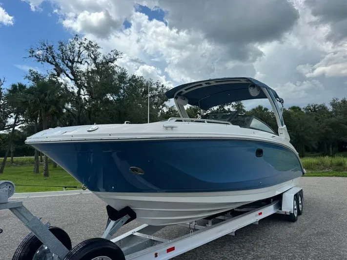  Yacht Photos Pics 2022 Sea Ray SDX 290 Outboard boat on trailer, under cloudy sky.