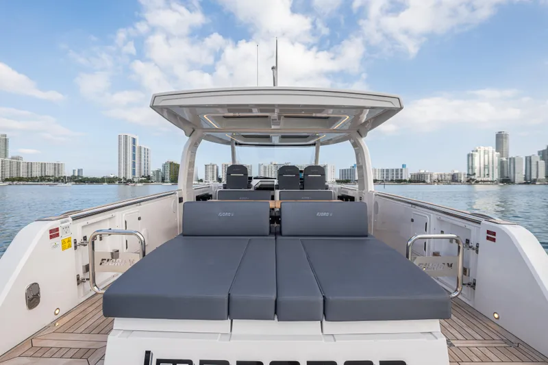 Improper Yacht Photos Pics 2024 Fjord 41 XL luxury yacht with spacious deck, city skyline in background.