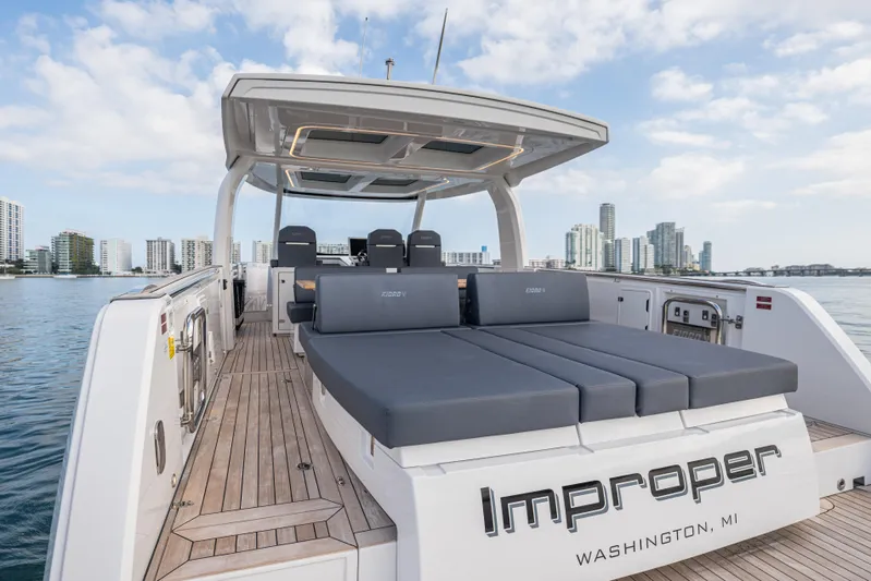 Improper Yacht Photos Pics 2024 Fjord 41 XL luxury yacht with spacious deck, city skyline in background.