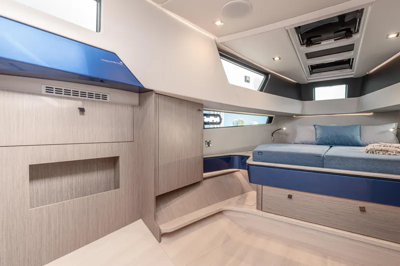 Improper Yacht Photos Pics Luxurious interior of 2024 Fjord 41 XL yacht with modern design and comfortable bedding.
