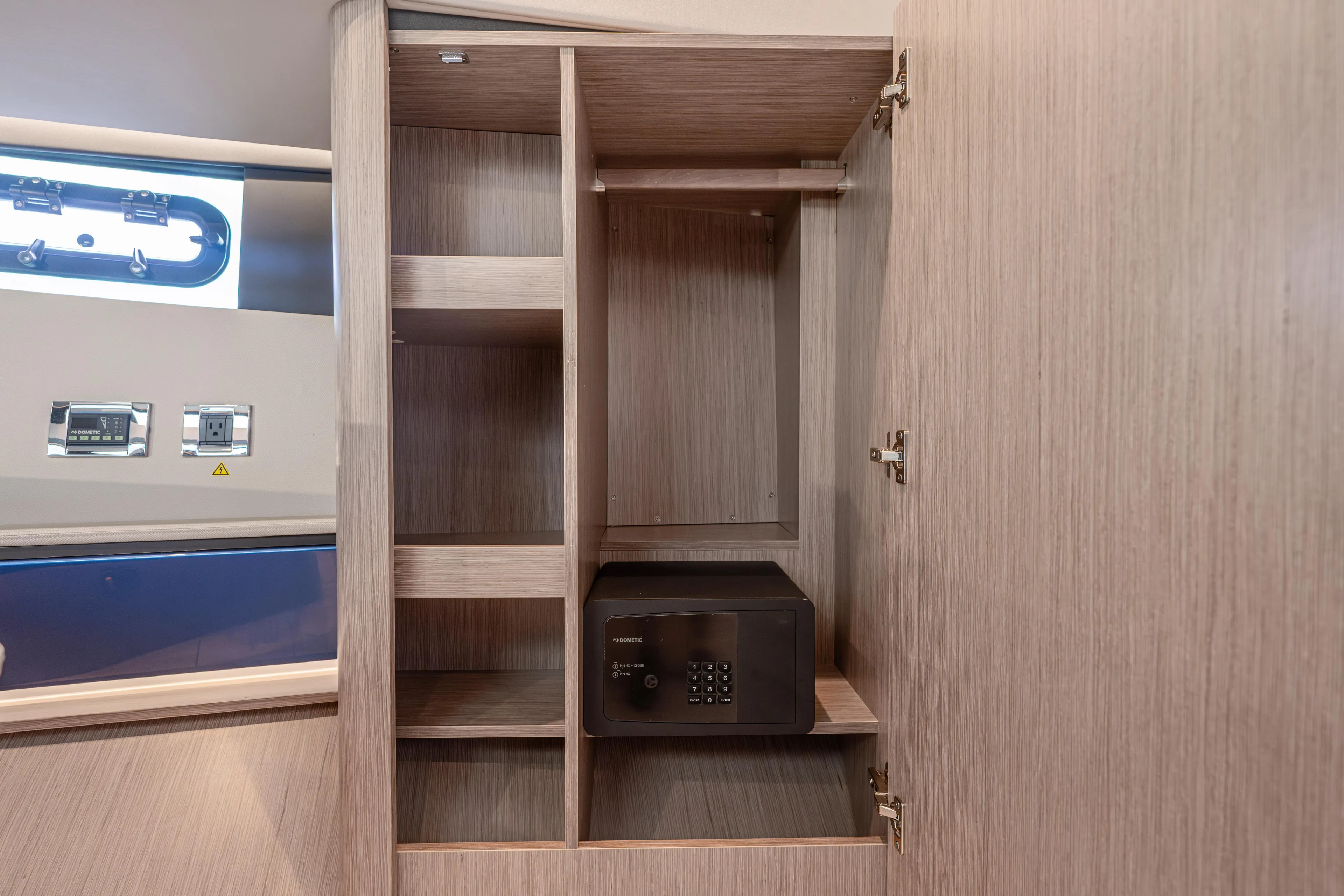 Improper Yacht Photos Pics 2024 Fjord 41 XL interior cabinet with safe and shelving.