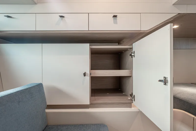 Improper Yacht Photos Pics 2024 Fjord 41 XL interior storage cabinets with open doors, showcasing modern design.