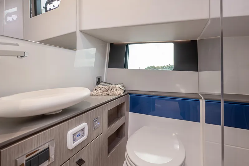 Improper Yacht Photos Pics Luxurious bathroom interior of 2024 Fjord 41 XL yacht with modern fixtures and window view.