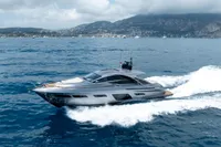 2024 Pershing 7X yacht cruising on open sea with scenic coastal backdrop.