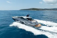2024 Pershing 7X yacht cruising on open sea with scenic coastline in background.