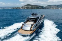 2024 Pershing 7X yacht cruising on open sea near scenic coastline.