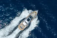 Aerial view of 2024 Pershing 7X yacht cruising on open blue sea.