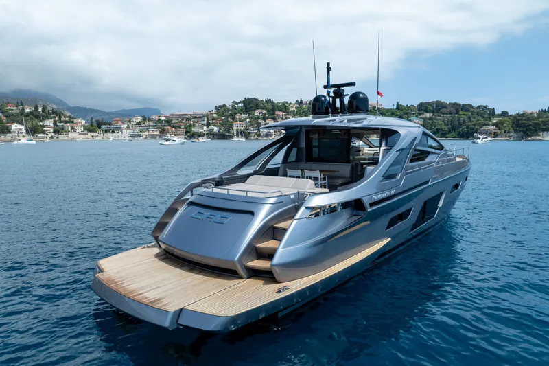 Ciao Yacht Photos Pics 2024 Pershing 7X yacht on serene blue waters near coastal town.