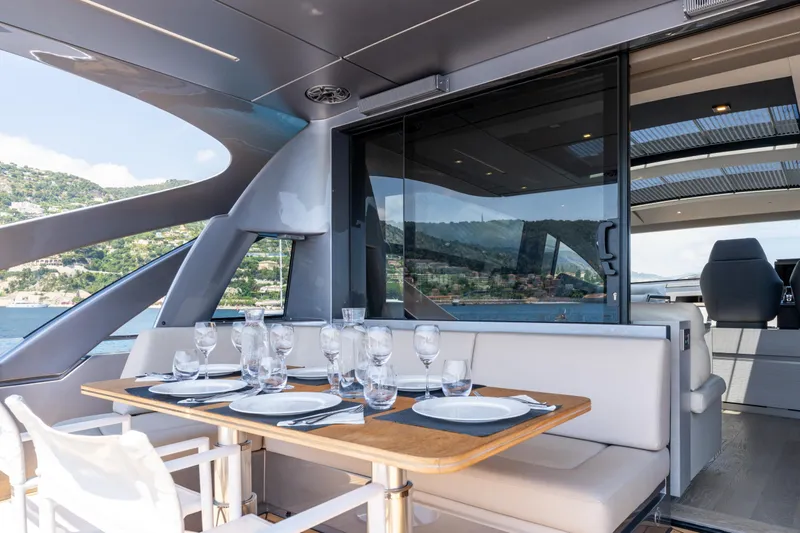 Ciao Yacht Photos Pics Luxurious 2024 Pershing 7X yacht dining area with elegant table setting and scenic ocean view.
