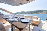 Luxurious dining setup on 2024 Pershing 7X yacht with scenic ocean view.