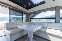 Luxurious interior of 2024 Pershing 7X yacht with panoramic windows and plush seating.
