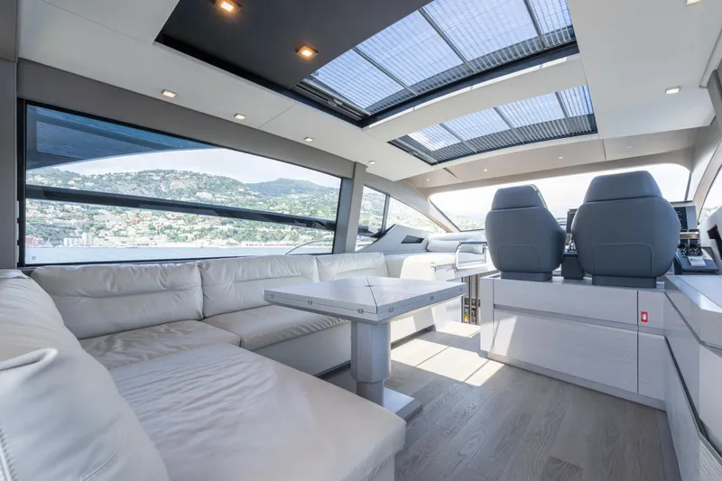 Ciao Yacht Photos Pics Luxurious interior of 2024 Pershing 7X yacht with panoramic windows and modern seating.