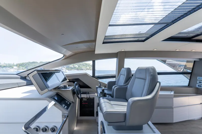 Ciao Yacht Photos Pics Luxurious interior of 2024 Pershing 7X yacht with modern helm and panoramic windows.