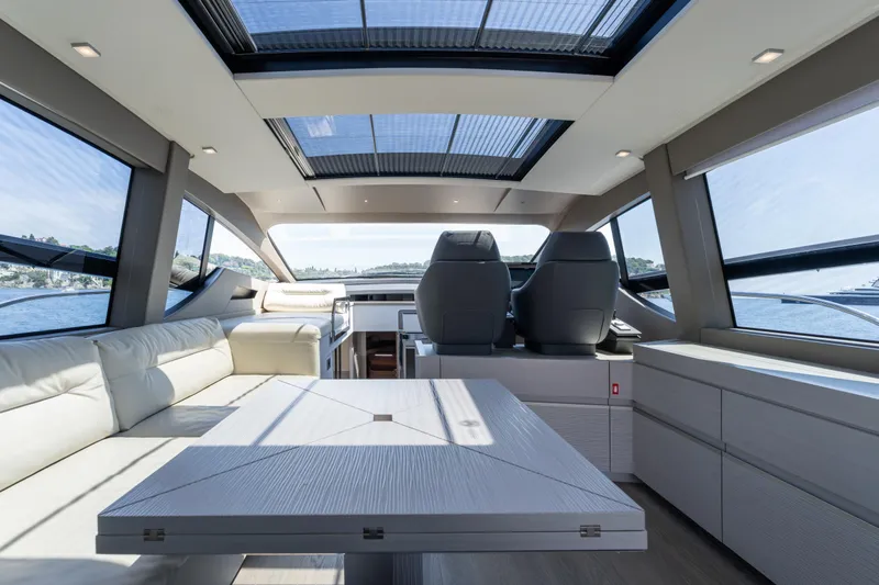 Ciao Yacht Photos Pics Luxurious interior of 2024 Pershing 7X yacht with panoramic windows and modern seating.