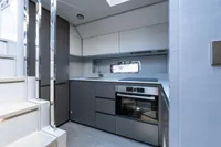 Modern kitchen interior on 2024 Pershing 7X yacht, featuring sleek cabinetry and appliances.