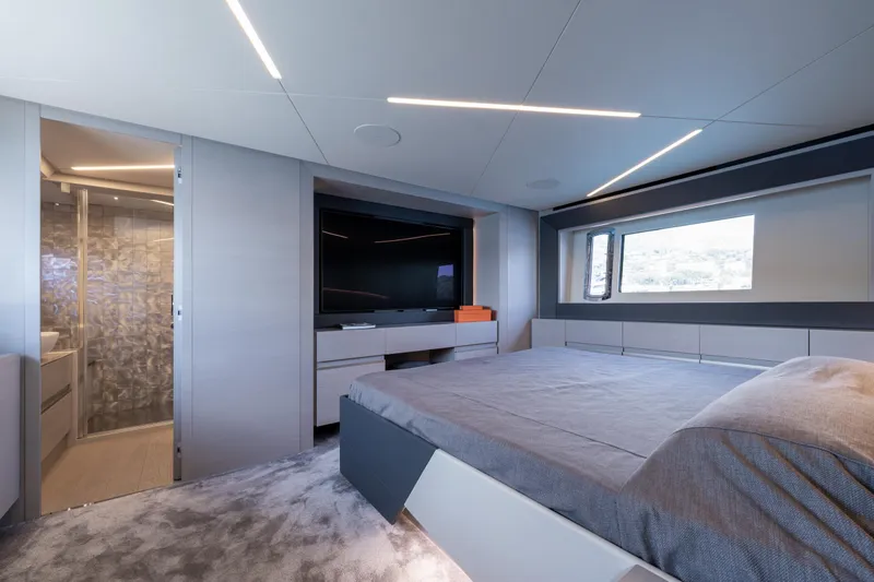 Ciao Yacht Photos Pics Luxurious interior of 2024 Pershing 7X yacht with modern bedroom and ensuite bathroom.