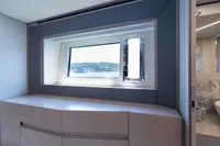 Luxurious interior of 2024 Pershing 7X yacht with scenic window view.