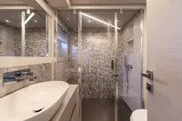 Luxurious bathroom interior of 2024 Pershing 7X yacht with modern fixtures and elegant design.