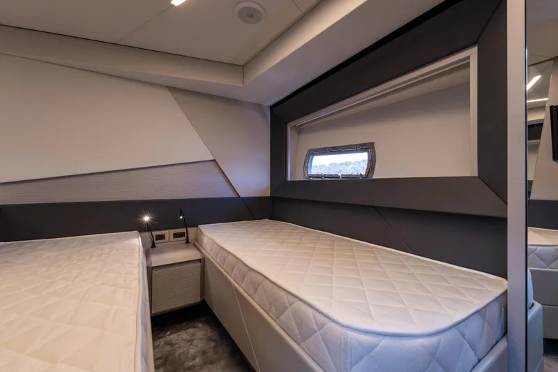 Ciao Yacht Photos Pics Luxurious twin cabin interior of 2024 Pershing 7X yacht, featuring modern design and comfortable bedding.